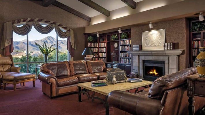 Comfortable common area with bookshelves and fireplace