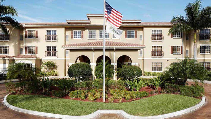 Exterior view of a senior living facility with landscaping