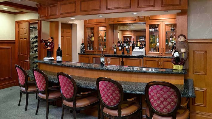 Well-appointed bar with granite countertop and various liquor bottles.