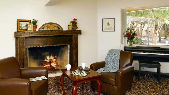 Cozy common area with a fireplace and chess set