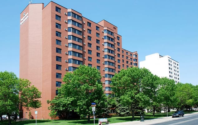Exterior of Augustana Health Care Center surrounded by greenery.