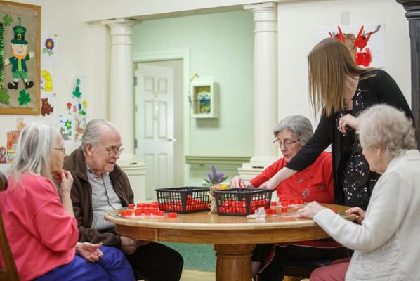 Residents and staff playing a game together in a common area