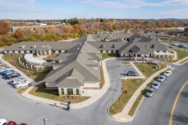 Aerial view of a senior living facility with gardens