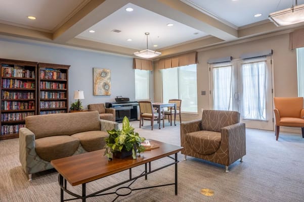 Bright common area with comfortable seating and bookshelves