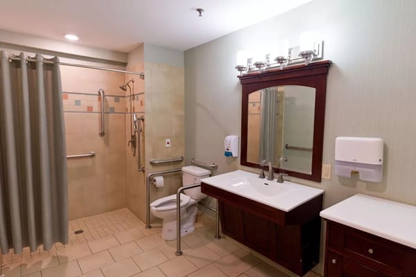 Well-lit private bathroom with accessibility features