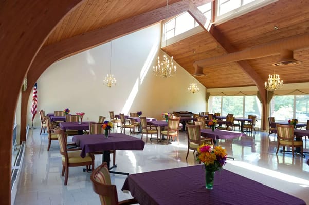 Bright dining area with floral centerpieces and chairs