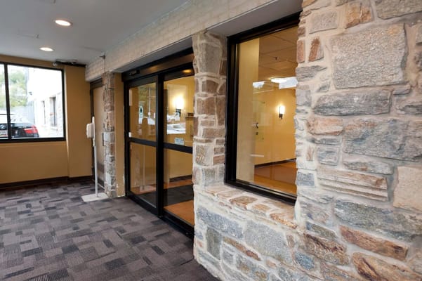 Front entrance with stone facade and large windows