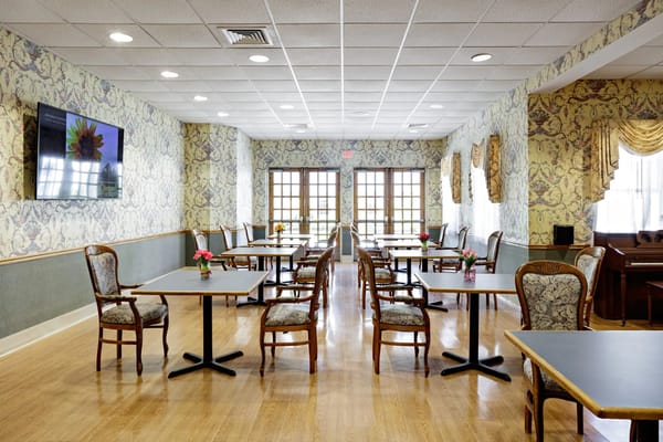 Bright dining room with tables and flowers