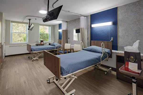 Shared resident room with two beds and seating area