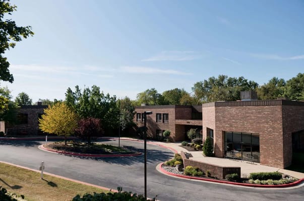 Exterior view of a senior living facility surrounded by trees