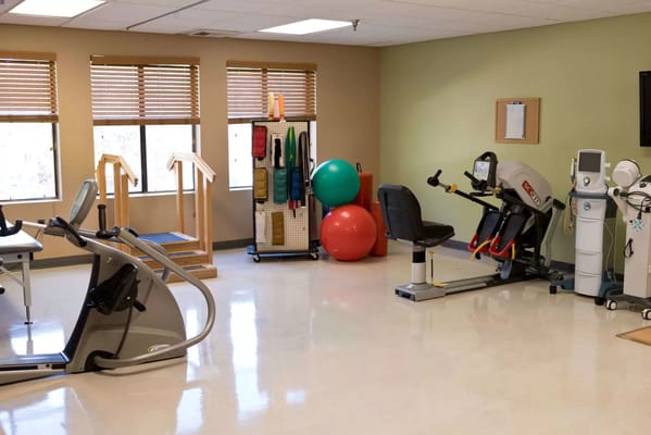 Interior view of a therapy room with fitness equipment