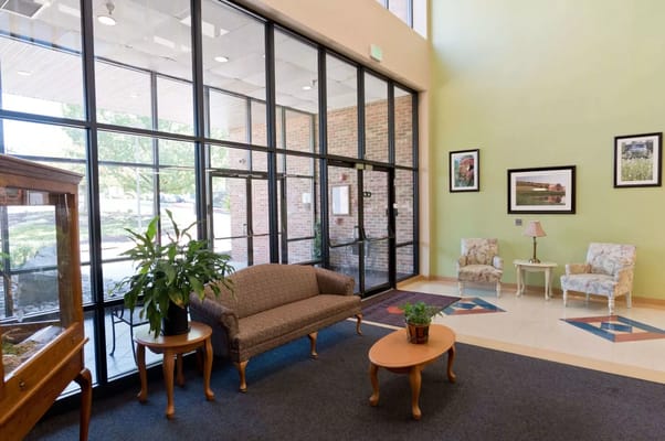 Bright lobby area with seating and large windows