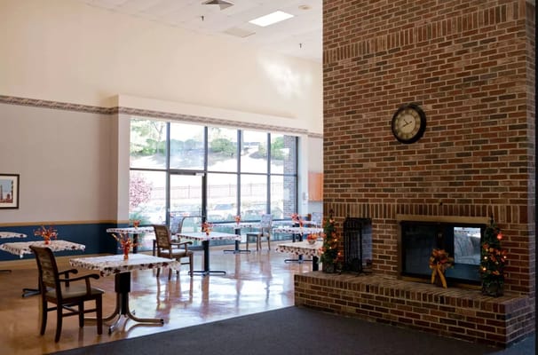 Bright dining area with decorative tables and fireplace