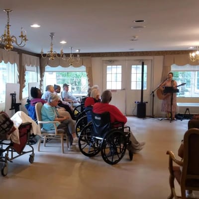 Residents enjoying a live music performance in a common area.