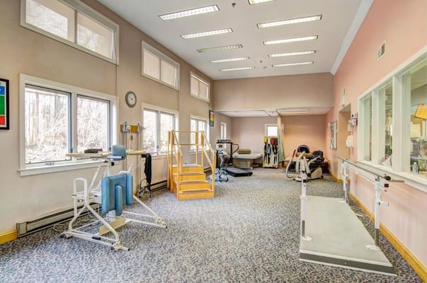 Interior view of a rehabilitation exercise room with equipment