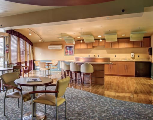 Bright common area with seating and kitchenette