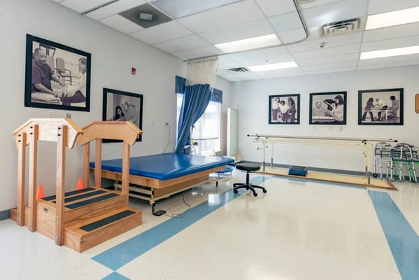 Interior view of therapy room with therapy equipment and photographs on the wall