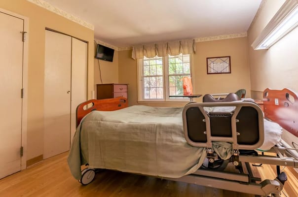 A private resident room with a hospital bed and window