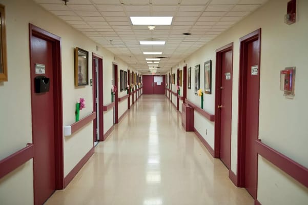 A corridor with doors and artwork in a facility