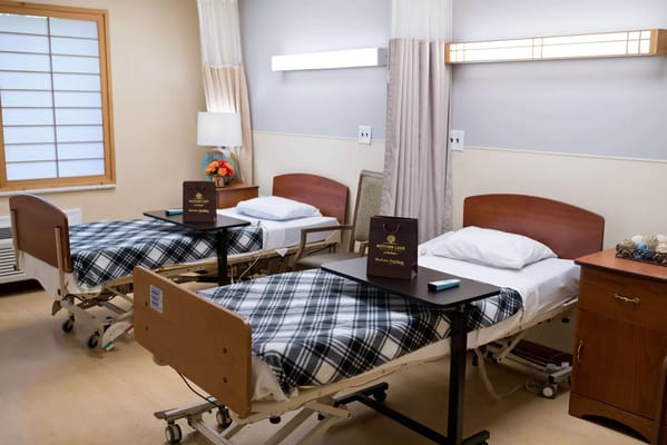 Two hospital beds in a shared resident room