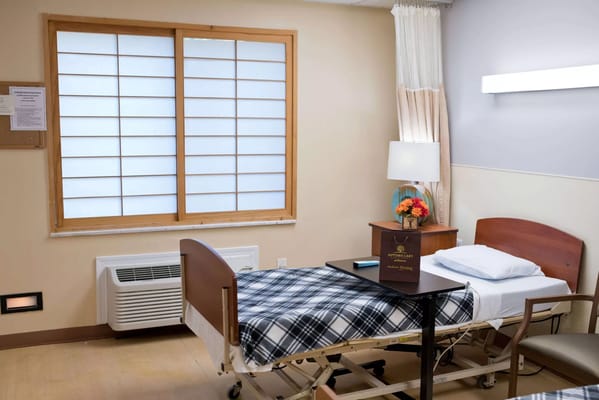 Interior view of a resident room with a bed and window