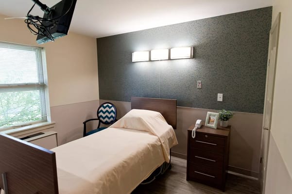 Private resident room with bed and furniture