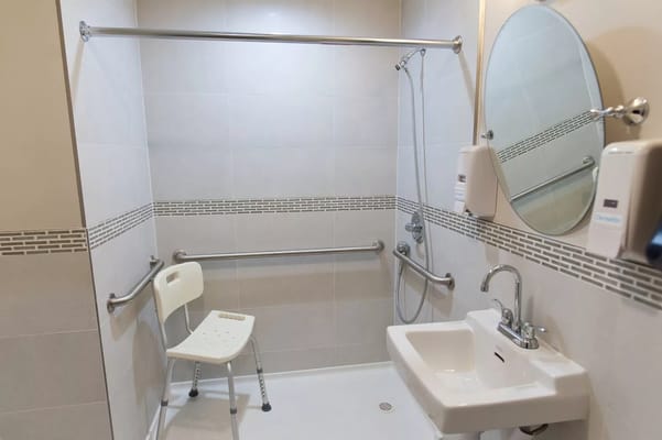 Accessible bathroom with grab bars and shower chair