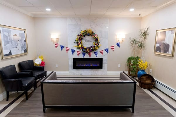 Cozy lounge area decorated with a wreath and flags