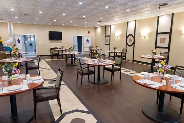 Dining room set up with tables and flower arrangements