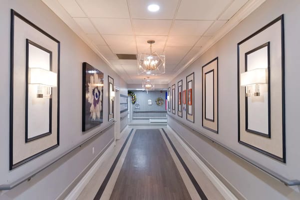 Well-lit hallway with decorative wall art