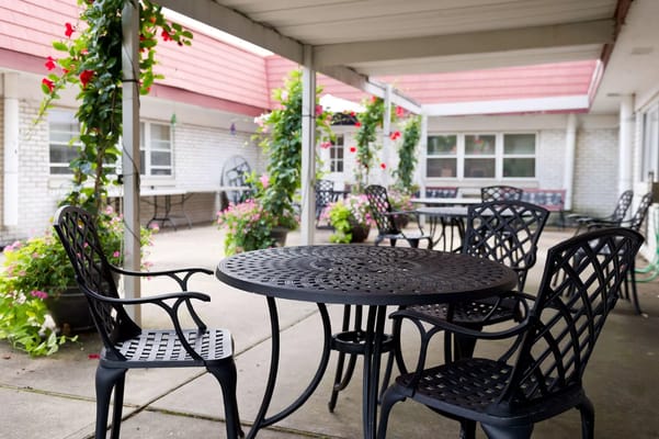 Outdoor seating area with tables and flowers