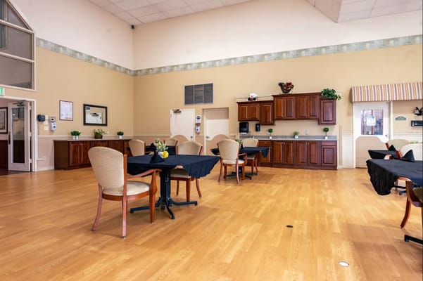 Spacious common area with tables and a kitchenette