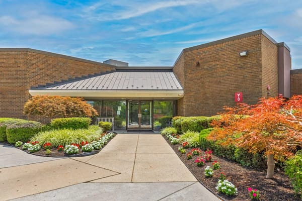 Entrance of the assisted living facility surrounded by gardens