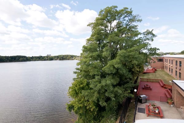 View of a serene waterfront with outdoor seating