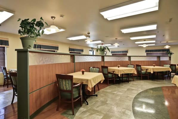 Sunny dining room with tables and chairs