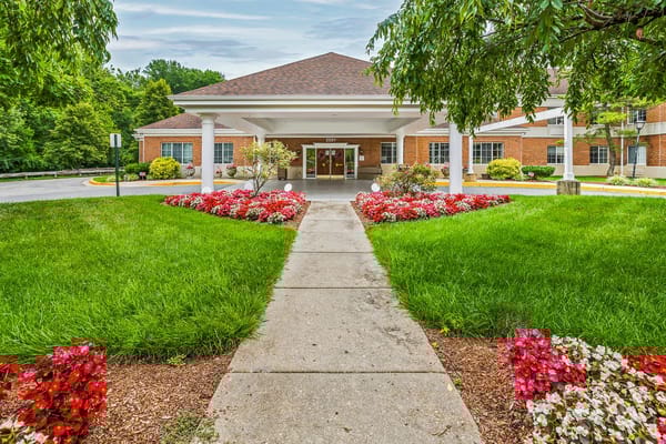 Well-maintained front entrance with flower beds
