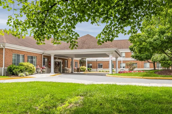 Front entrance of a senior living facility with a landscaped exterior