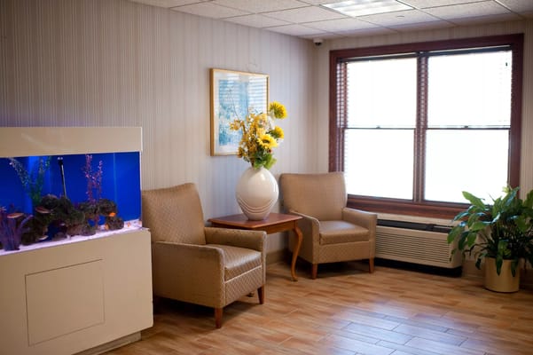Bright and welcoming common area with seating and aquarium