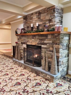 Cozy interior fireplace with stone wall and decor