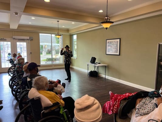 Residents enjoying a performance in a common area