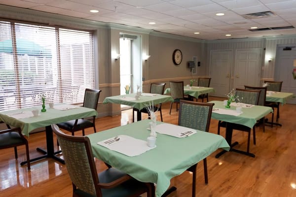 Bright dining room with tables set for meals