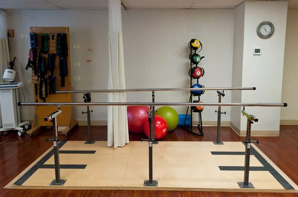 Rehabilitation area with therapy bars and exercise equipment