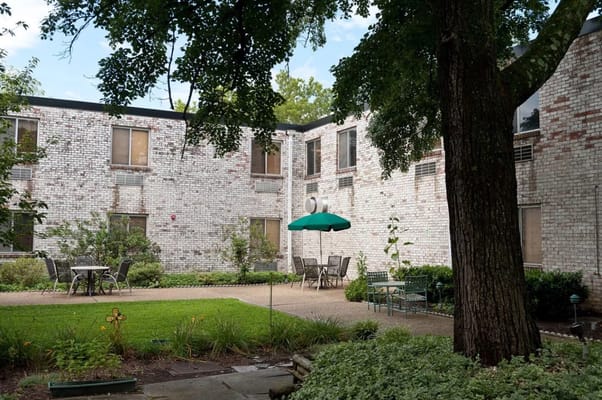 Outdoor courtyard with tables and green umbrella
