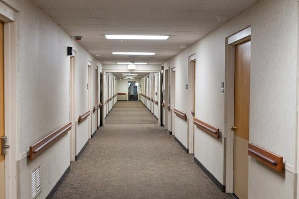 A hallway with doors to resident rooms