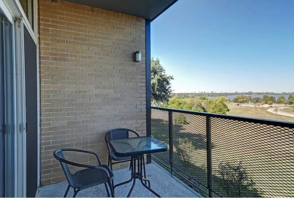 Balcony view overlooking greenery and water
