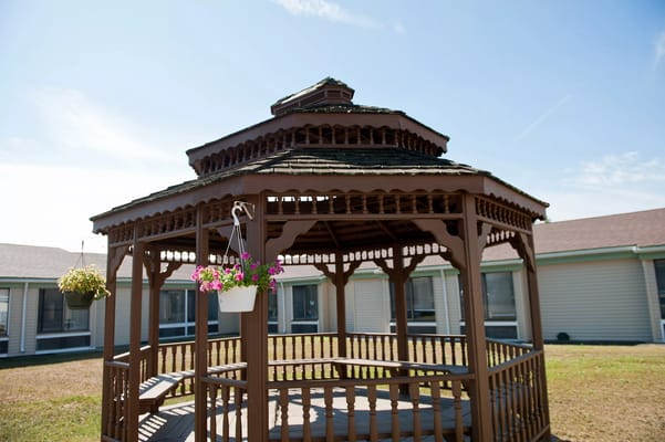 Wooden gazebo in a sunny outdoor area