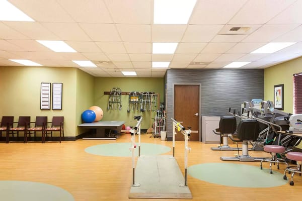 Therapy room with exercise equipment and therapy bars