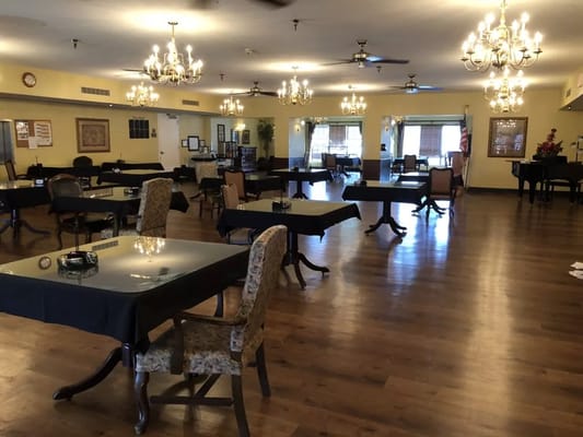 Spacious dining room with tables and chandeliers at Avalon Place of Monroe.