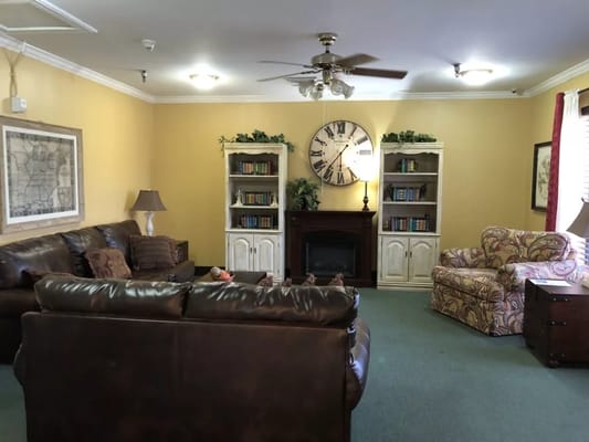 Spacious living room with comfortable seating and bookshelves.