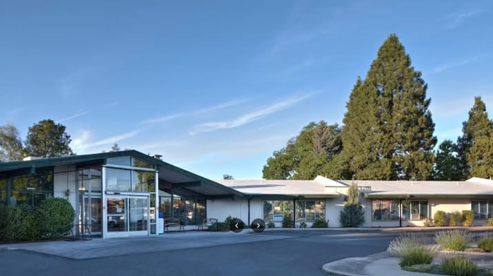 Exterior view of a senior living facility with landscaped grounds